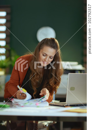 business owner woman in green office working with documents 102792817
