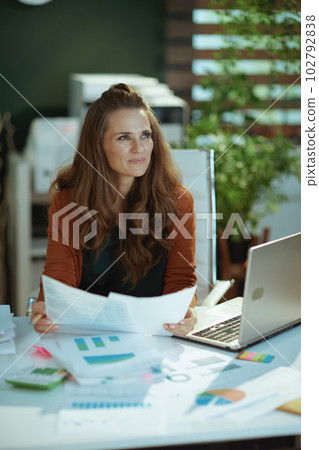 business owner woman in green office working with documents business owner woman in green office working with documents 102792838