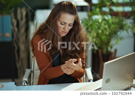 unhappy stylish business owner woman in green office 102792844