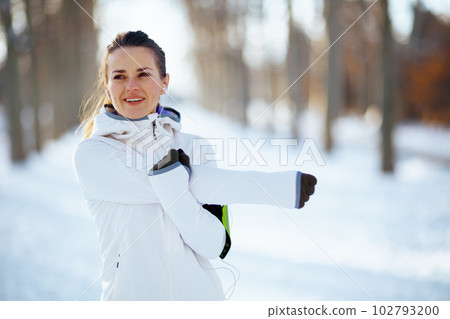 happy fit woman in white jacket stretching happy fit woman in white jacket stretching 102793200