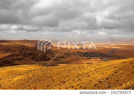 Top view of a canyon meandering through high sandstone mountains in the desert, Jordan 102793873