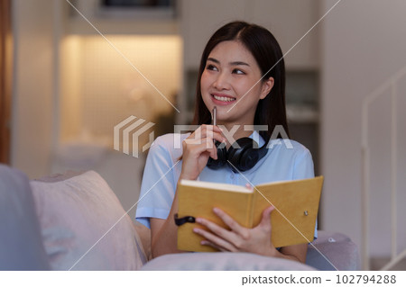 Attractive Asian woman resting comfortable living room and reading book, Relax, Sofa, Lifestyle Attractive Asian woman resting comfortable living room and reading book, Relax, Sofa, Lifestyle 102794288