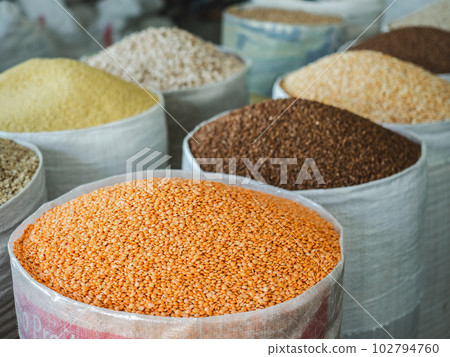 Bags and bowls with fragrant spices lying in the market 102794760