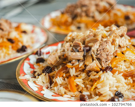 Plates with fragrant pilaf are on the table Plates with fragrant pilaf are on the table 102794766