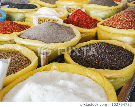 Bags and bowls with fragrant spices lying in the market 102794783