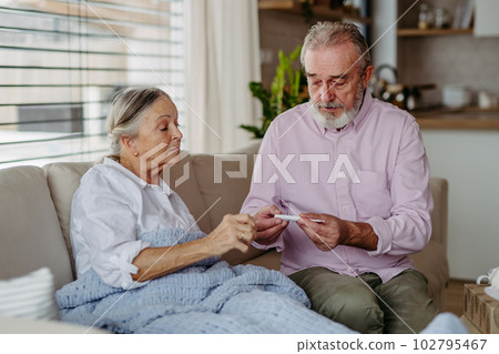 Senior man taking care of his ill wife. Senior man taking care of his ill wife. 102795467