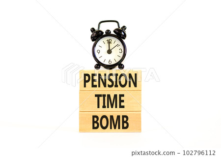 Pension time bomb symbol. Concept words Pension time bomb on wooden blocks on a beautiful white table white background. Black alarm clock. Business pension time bomb concept. Copy space. 102796112