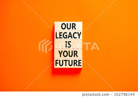 Legacy and future symbol. Concept words Our legacy is your future on wooden blocks. Beautiful orange table orange background. Business legacy and future concept. Copy space. 102796144