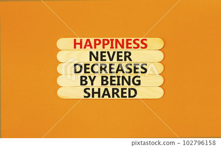 Happiness symbol. Concept words Happiness never decreases by being shared on wooden stick. Beautiful orange table orange background. Motivational Happiness concept. Copy space. Happiness symbol. Concept words Happiness never decreases by being shared on wooden stick. Beautiful orange table orange background. Motivational Happiness concept. Copy space. 102796158