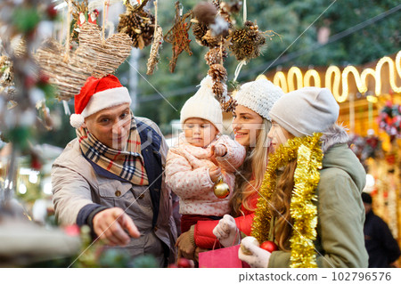 Family buying Christmas decorations 102796576