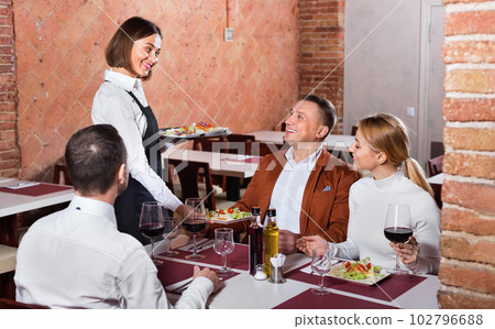 Female waiter bringing order to visitors 102796688