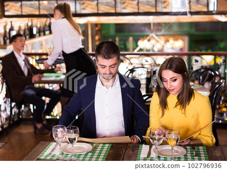Couple is choosing order for dinner Couple is choosing order for dinner 102796936