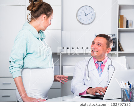 Doctor and pregnant visitor 102797525