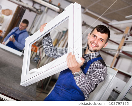 Man worker is demonstrating PVC manufacturing output Man worker is demonstrating PVC manufacturing output 102797555