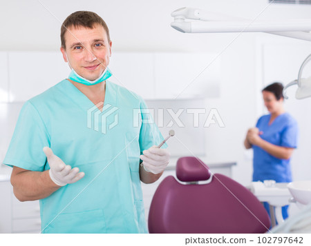 Portrait of adult dentist in medical center 102797642