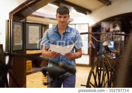 Man with information booklet in museum 102797714