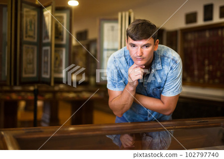 Man looking at stands with exhibits Man looking at stands with exhibits 102797740
