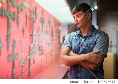 Man looking at stands with exhibits 102797751