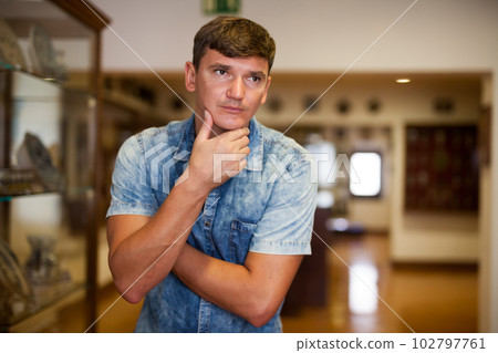 Man standing at hall of historical museum 102797761