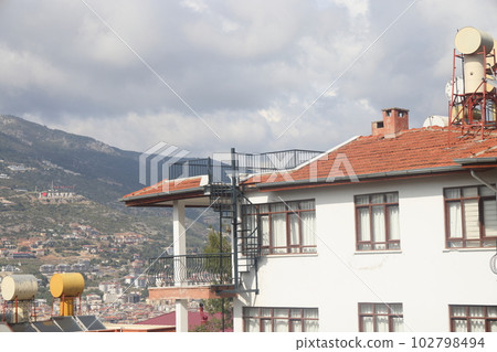 View of the highway, houses and mountains in Alanya orange groves. Evening time, Turkiye, April 2023 View of the highway, houses and mountains in Alanya orange groves. Evening time, Turkiye, April 2023 102798494