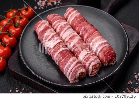 Raw minced meat wrapped in bacon with salt and spices or cevapcici 102799120