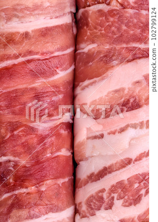 Raw minced meat wrapped in bacon with salt and spices or cevapcici Raw minced meat wrapped in bacon with salt and spices or cevapcici 102799124