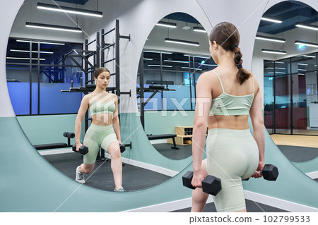 Teenage female doing sports workout in gym of an apartment complex Teenage female doing sports workout in gym of an apartment complex 102799533