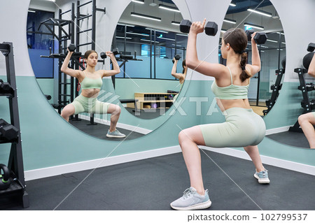 Teenage female doing sports workout in gym of an apartment complex Teenage female doing sports workout in gym of an apartment complex 102799537