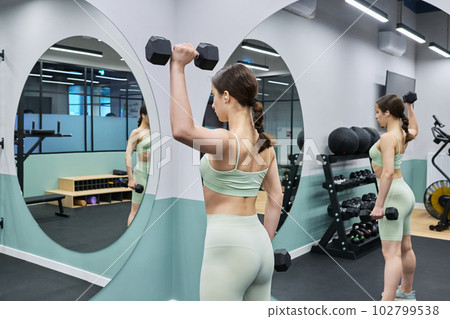 Teenage female doing sports workout in gym of an apartment complex Teenage female doing sports workout in gym of an apartment complex 102799538