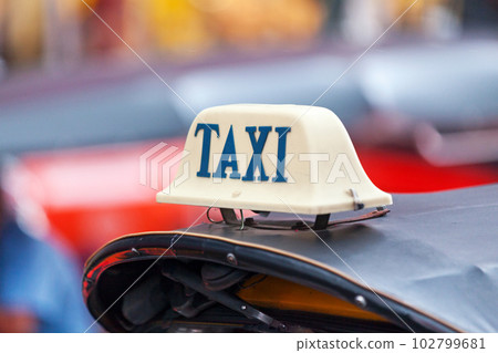 Taxi sign on the roof of a tuk tuk 102799681