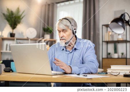 Remote employee making video call via laptop in home office 102800223