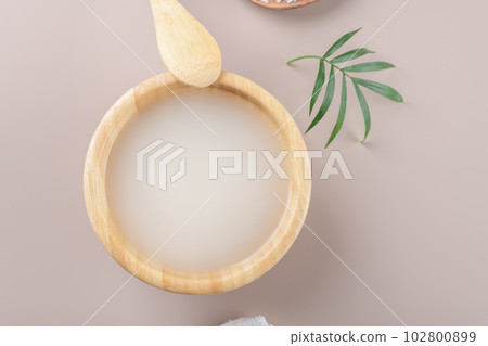 Homemade cosmetic rice water with ingredients on beige background 102800899
