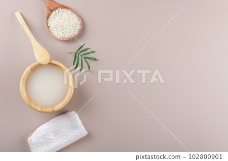 Homemade cosmetic rice water with ingredients and beauty kit on beige background, top view copy space, home spa flat lay Homemade cosmetic rice water with ingredients and beauty kit on beige background, top view copy space, home spa flat lay 102800901