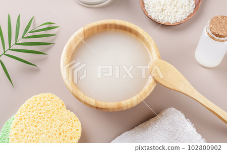 Homemade cosmetic rice water with ingredients on beige background Homemade cosmetic rice water with ingredients on beige background 102800902