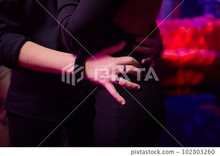 Close up of young couple hold hands talking sharing secrets showing love and care, husband and wife have tender close moment together, demonstrate support and understanding. Close up of young couple hold hands talking sharing secrets showing love and care, husband and wife have tender close moment together, demonstrate support and understanding. 102803260