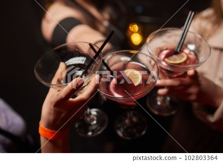 Clinking glasses with alcohol and toasting, party. 102803364