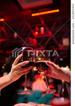 Clinking glasses with alcohol and toasting, party. 102803447