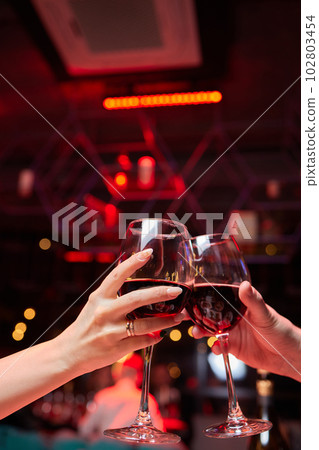Clinking glasses with alcohol and toasting, party. 102803454