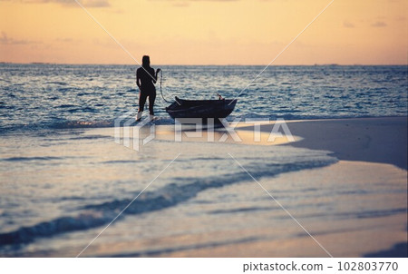 woman with a boat at sea woman with a boat at sea 102803770