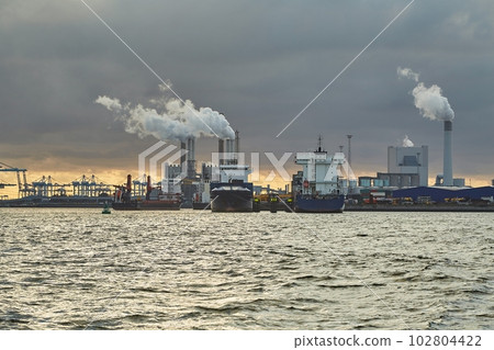 Industrial oil port and facilities smoking in the background 102804422