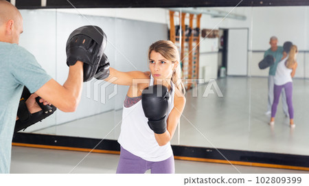 Young woman boxing during self defense workout 102809399