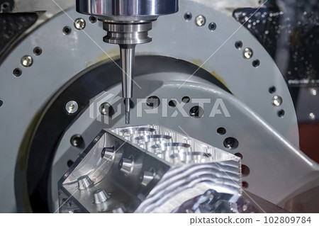 Close up scene the 5-axis machining center cutting the V8 engine cylinder block with solid ball end mill tool. 102809784