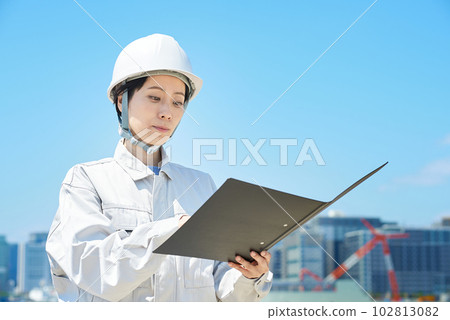 A woman in work clothes checking the site A woman in work clothes checking the site 102813082