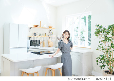 young woman standing in the kitchen 102813141