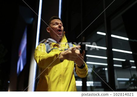 Male tourist with backpack got lost in city uses navigation Male tourist with backpack got lost in city uses navigation 102814021