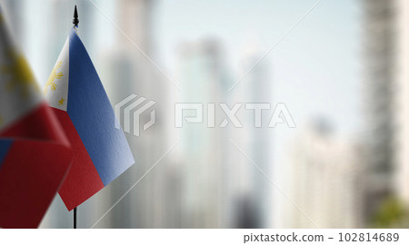 Small flags of the Philippines on an abstract blurry background 102814689