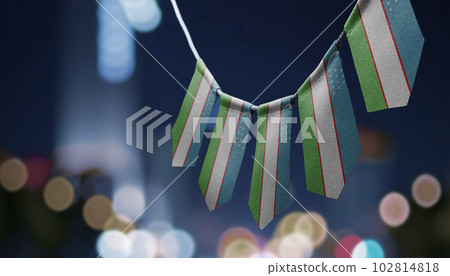 A garland of Uzbekistan national flags on an abstract blurred background 102814818