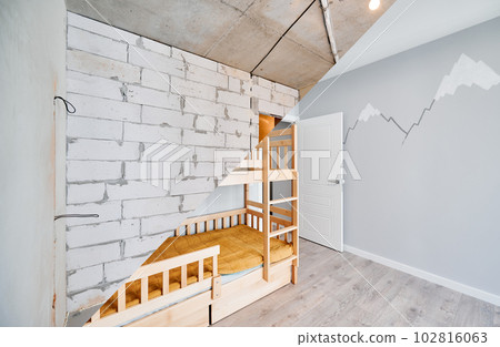 Old apartment room with brick wall and new renovated flat with parquet floor and kid house bed. Comparison of children room with wooden bunk bed before and after renovation. Old apartment room with brick wall and new renovated flat with parquet floor and kid house bed. Comparison of children room with wooden bunk bed before and after renovation. 102816063