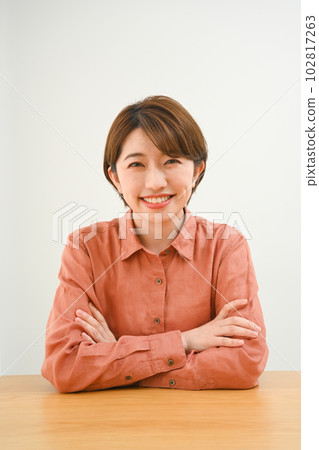Young woman posing at the table Young woman posing at the table 102817263