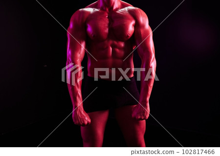 Man professional bodybuilder athlete naked torso in sports, isolated on multicolored background in neon light. Advertising, sports, active lifestyle, colored light, competition, challenge concept. Man professional bodybuilder athlete naked torso in sports, isolated on multicolored background in neon light. Advertising, sports, active lifestyle, colored light, competition, challenge concept. 102817466